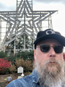 The author in sunglasses standing infrront of a large star atop a hilling Roanoke, VA.